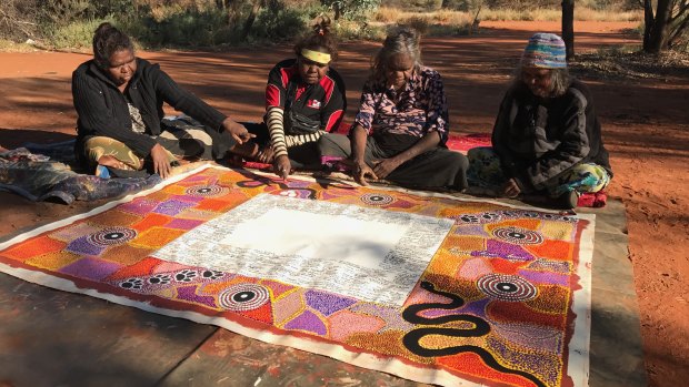 Road map for empowerment: The artists of the Uluru Statement of the Heart at Uluru in 2017. 