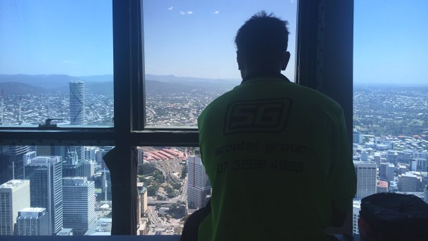 Tradies enjoy the view from their "lunch room" on the upper floors of Brisbane's Skytower. 