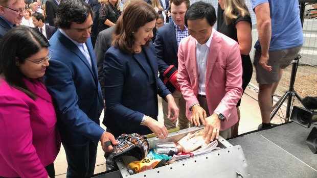 The Queensland time capsule is buried under the Queens Wharf Casino development, watched by Education Minister Grace Grace,  Premier Annastacia Palaszczuk, Jonathan Thurston and Queensland Ballet director Li Cunxin.