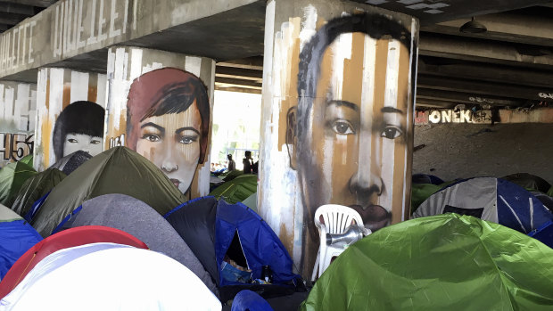 Migrants camp under a bridge in Paris. 