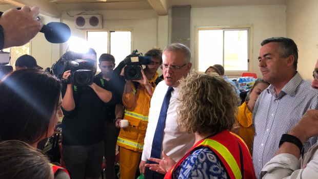 Scott Morrison and Darren Chester arrive in Bairnsdale on Friday . The PM had earlier been heckled in the NSW town of Cobargo.