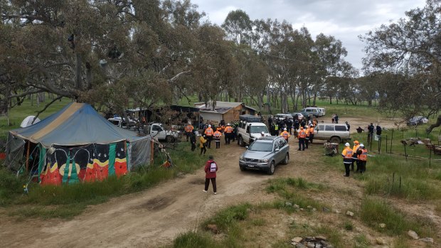 Police officers and roads workers move into the Djab Wurrung site on the Western Highway on Tuesday morning.