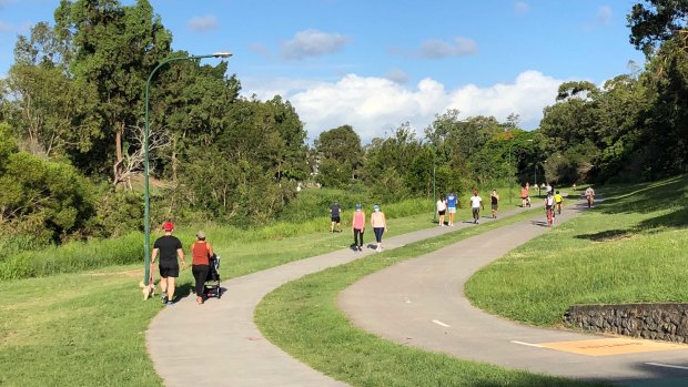 Walkers and joggers at Kedron Brook in Brisbane's northern suburbs on Sunday.
