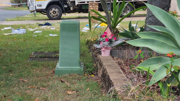 Flowers left at a house in North Lakes where a woman died after a confrontation with intruders late on Boxing Day.