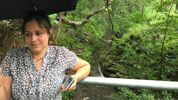 Wildlife carer Irish Hing beside Toowong Creek, where threatened species and a 300-year-old tree could be impacted by plans to expand the campus.