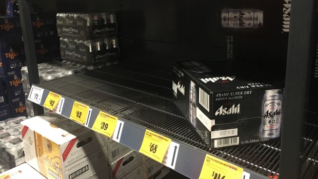 Beer and wine shelves were beginning to empty around Brisbane on Sunday night.