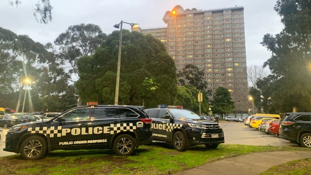 Police outside the Flemington public housing towers which were placed under 'hard lockdown' at 4pm on Saturday.