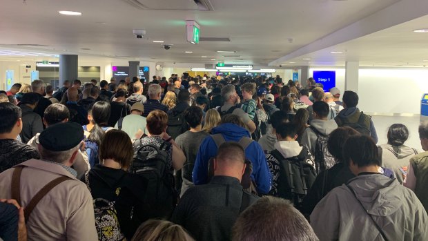 The arrivals queue at Sydney Airport's international terminal as waiting times stretched for 90 minutes after an IT systems outage affected all passengers departing or arriving in Australia on Monday. 