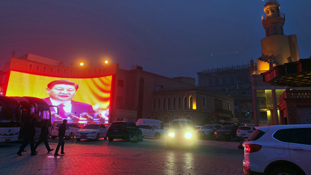 A large image of Chinese President Xi Jinping is beamed in a square in Kashgar, an ancient city in Xinjiang, north-west China.