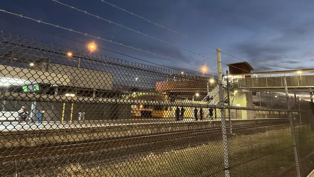 Police conduct wanding searches at Goodna Railway Station.