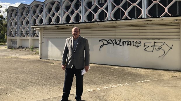 Councillor Charles Strunk outside the derelict building in 2018.