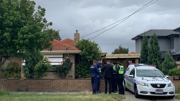 Forensic officers at the Gladstone Road property, where a man apparently loitered before an alleged assault on Carlton Road. 