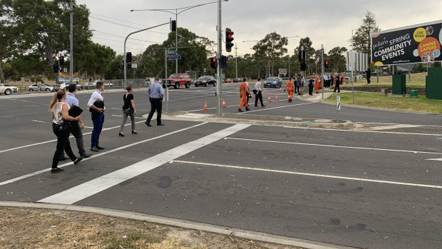 Police and SES do a line search from a Bundoora tram stop to where a woman's body was found on Wednesday morning.