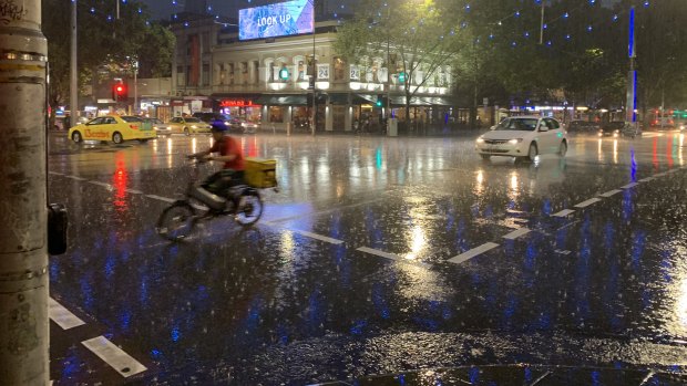 Rain hits Melbourne's CBD near the corner Lonsdale and Russell Streets. 