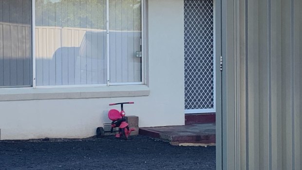 A tricycle remained at the front of the house on Tuesday morning.
