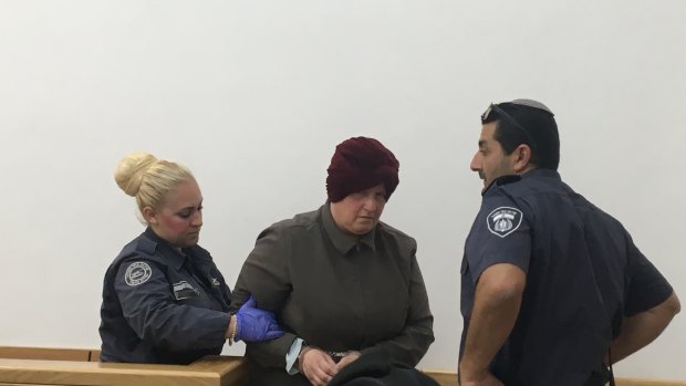 Malka Leifer being led away after she left court early feeling unwell on May 2, 2018. 
