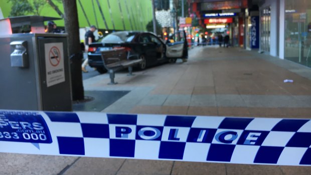 A car is seen on a kerb where pedestrians were hit in the accident in Brisbane's George Street.