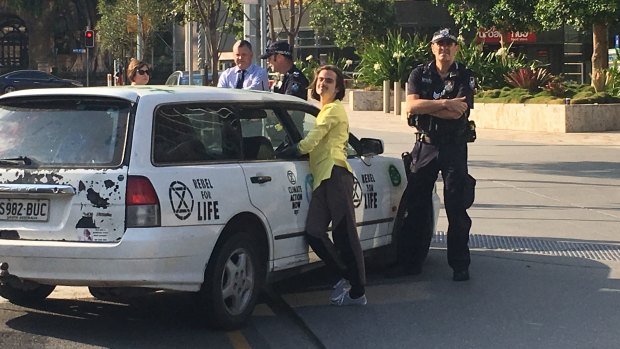 Brisbane protester Eric Herbert locked himself to a car at the base of the Queensland government headquarters.