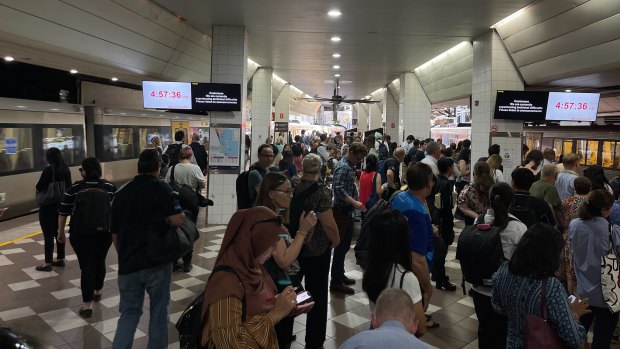 People crowd the platform at Central Station after lightning caused a signal fault and created commuter chaos in Brisbane on Thursday.