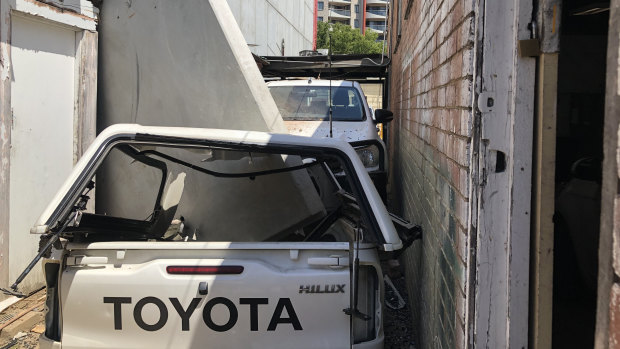 The concrete panel also appears to have crushed a car.