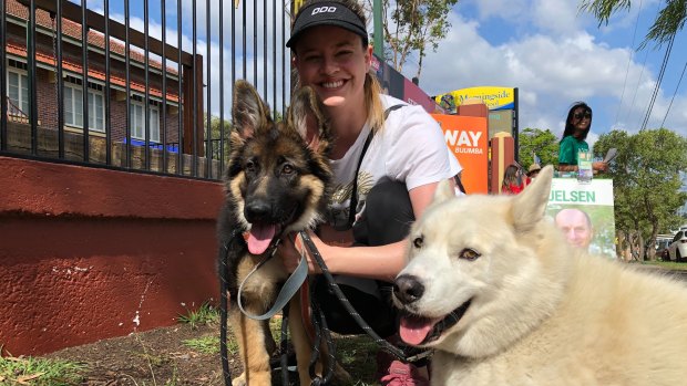 Jacqueline, a teacher at Morningside State School, votes with her dogs Honey and Boo.
