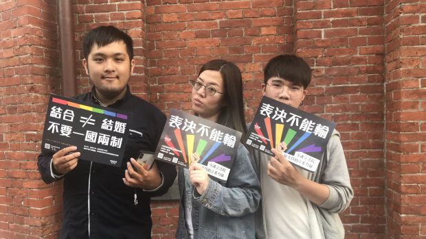 Zhang Jie, left, with friends outside Taipei’s Red House after the Taiwanese Parliament voted to legalise same-sex marriage.