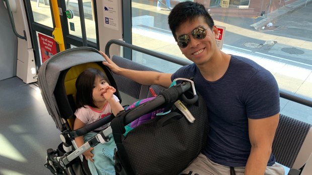 Josh Koh and daughter Arabelle ride the tram from Randwick to the city on Monday morning. 