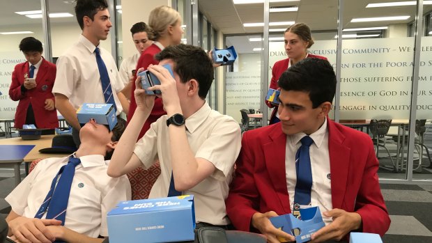 Southern Cross Catholic College students (from left) Oliver Sims, Max Fallon and Riley Diaz look at a 3D view of Queensland's newest university.