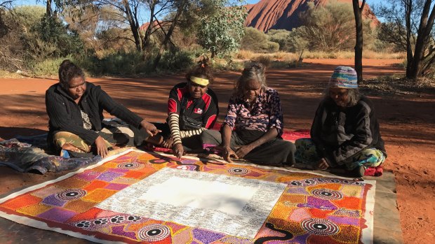 The artists of the Uluru Statement at Uluru in 2017. 