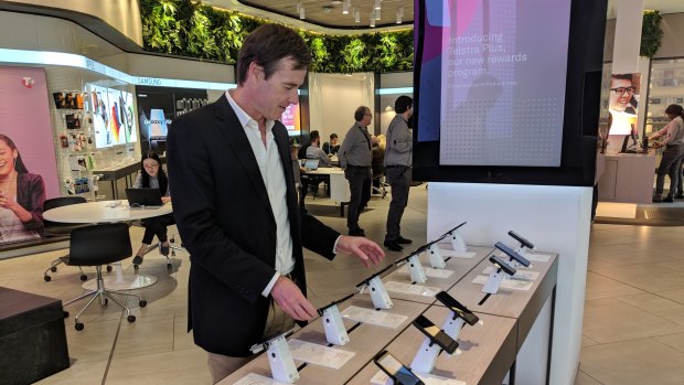 Phil, browsing smartphones, says a new Huawei operating system would not be appealing to him. 