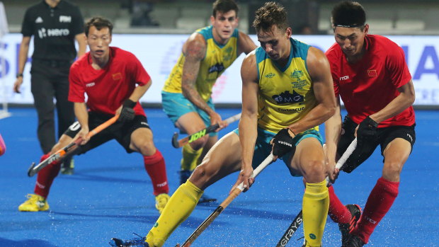 Australia's Tom Craig  in action against Meng Dihao (R) of China during the men's Field Hockey World Cup match between Australia and China.