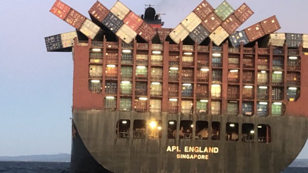 Containers cling precariously to  APL England last Sunday after other cargo fell overboard.