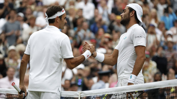 No sweat: Roger Federer shakes hands with Matteo Berrettini after easing past the Italian.