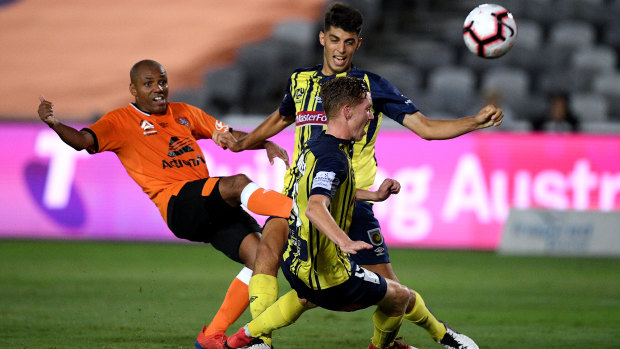 Henrique of the Roar has a shot at goal blocked by Jonathan Aspropotamitis (centre) and Kye Rowles of the Mariners during the Round 20 A-League match in Gosford on Friday.