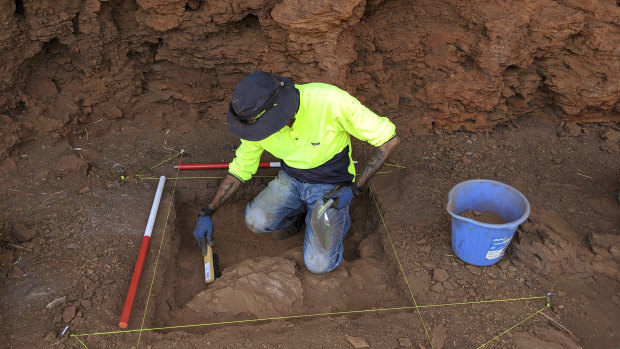 Eastern Guruma traditional owner Kelvin Hughes undertaking excavation within one of the rock shelters. 