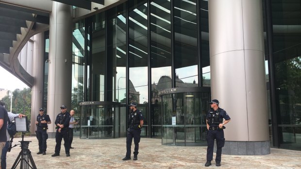 Police officers outside 1 William Street, which was in lockdown ahead of the expected arrival of Extinction Rebellion protesters.