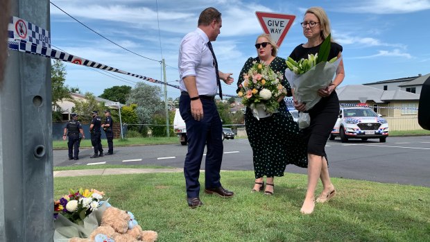 Brisbane lord mayor Adrian Schrinner, his wife Nina, and local councillor Fiona Cunningham place flowers at the scene.