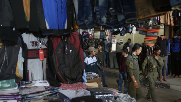 Members of the Kurdish internal security forces patrol at a popular market, in Manbij, north Syria in March.