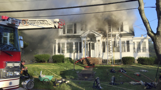 Firefighters battle a house fire in North Andover, Massachusetts.