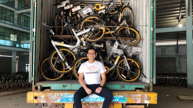 Less Walk founder Mike Than Tun Win with a container of oBikes.