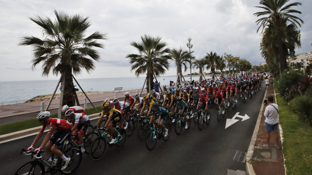 The pack rides along the beach of the Promenade des Anglais during the first stage of the Tour de France cycling race over 156 kilometers (97 miles) with start and finish in Nice, southern France, Saturday, Aug. 29, 2020.