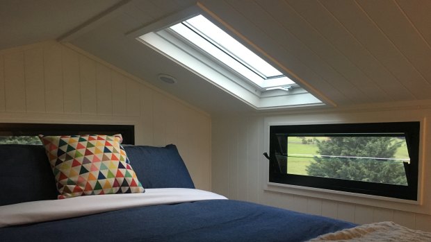 Loft bedroom, complete with skylight roof window at Clyde, one of Tilba Lake Camp’s two tiny houses.