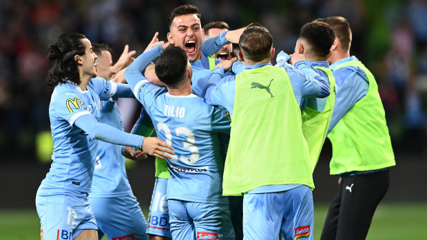 Scott Galloway of Melbourne City celebrates with his teammates after scoring their third goal during the A-League grand final.
