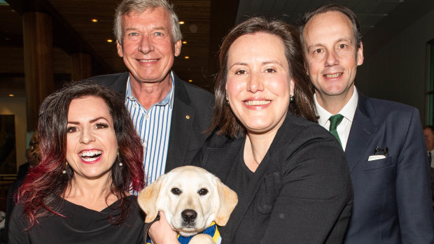 Nicole Pedersen-McKinnon (left) at Parliament for the launch of the 2018 National Financial Capability Strategy, with National Financial Literacy Board chairman Paul Citheroe, former financial services minister Kelly O'Dwyer (with a seeing eye dog in training that was shadowing her around Parliament) and ASIC chairman James Shipton.