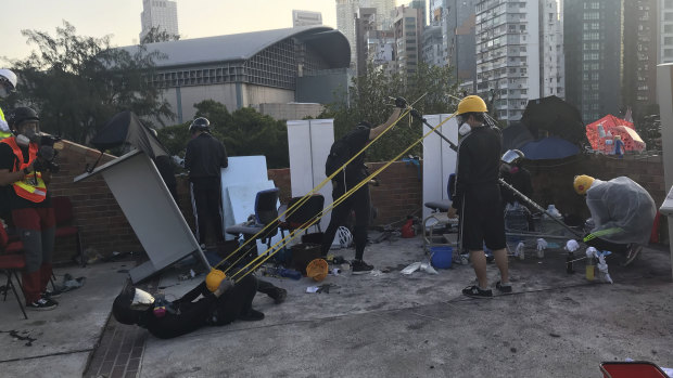 Protesters use a catapult to hurl rocks police laying siege to Hong Kong Polytechnic University.