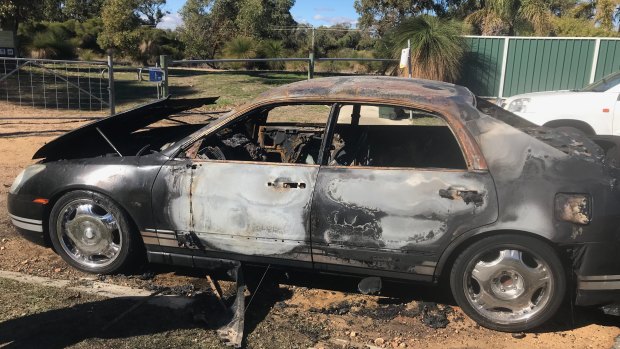 The burnt-out car.