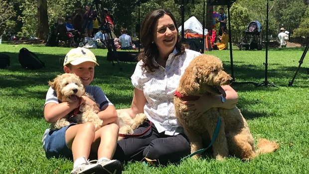 Premier Annastacia Palaszczuk holds Winton, while her nephew Harry holds Oakey after a news conference in Sinnamon Park.