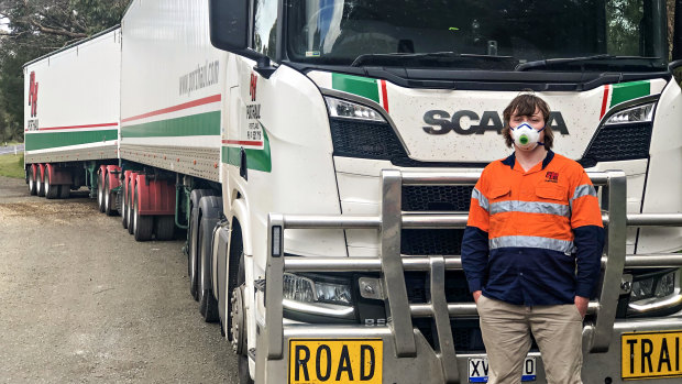 Road-train driver Rick McQuade returns to his truck on the South Australia-Victoria border after submitting to another of his weekly COVID-19 tests. 