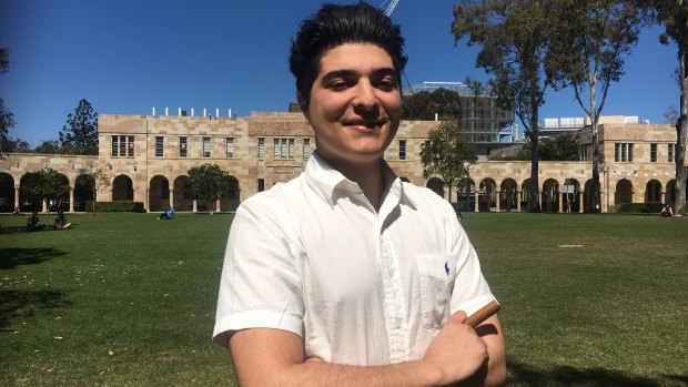 Suspended student Drew Pavlou poses with his “victory cigar” in UQ’s Great Court.