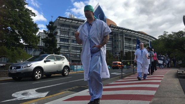 Workers strike outside Brisbane's Princess Alexandra Hospital over the state government’s planned public service wage freeze. 